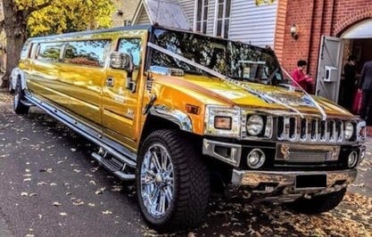 Gold color stretch hummer booked for wedding car hire in Melbourne waiting for customers